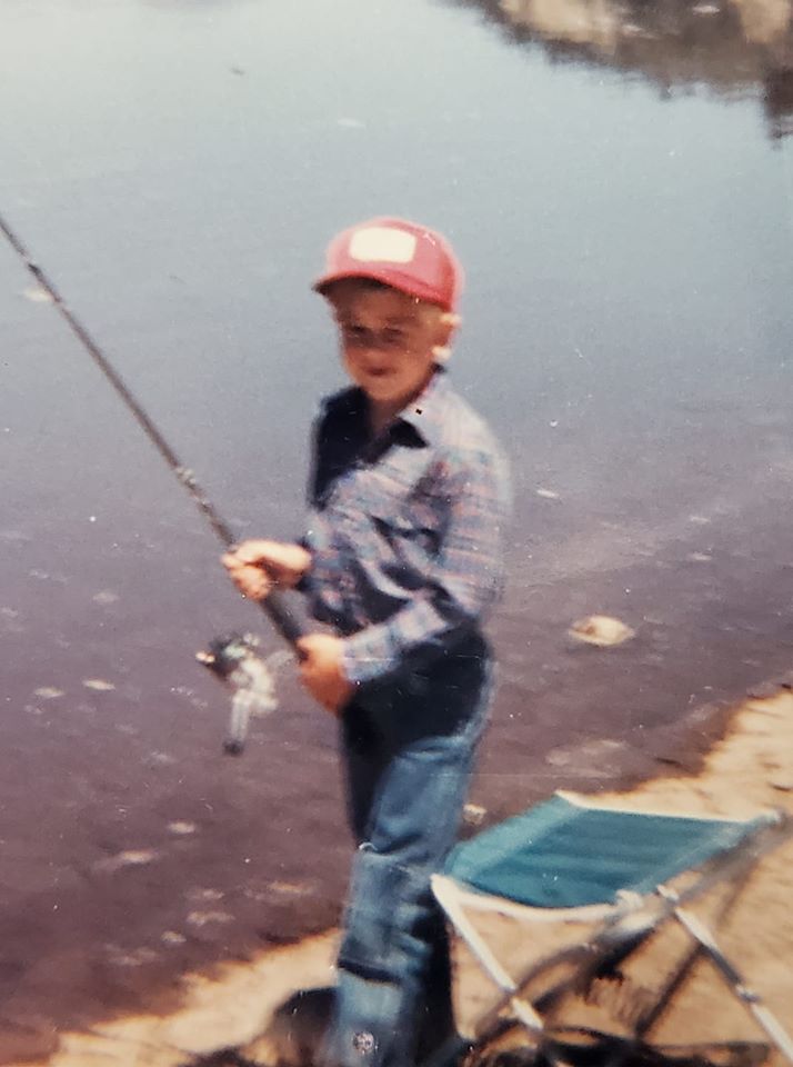 GSO Fishing owner Andy Cochran holding his fishing pole at the lakes edge when he was a child