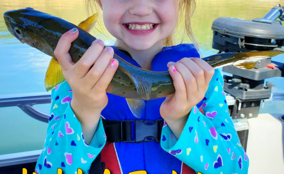How To Hold A Fish - GSO Fishing - Young Lady holding a trout and smiling