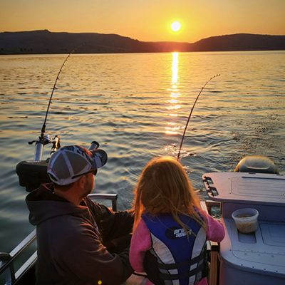 GSO Fishing - Guide Andy Cochran and Junior Guide Reeling In A Fish At Sunrise On Blue Mesa Reservoir in Gunnison, CO