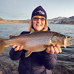 GSO Owner Stormy Cochran holding big Brown Trout she caught on GSO's Kokanee Fry Finesse Jig