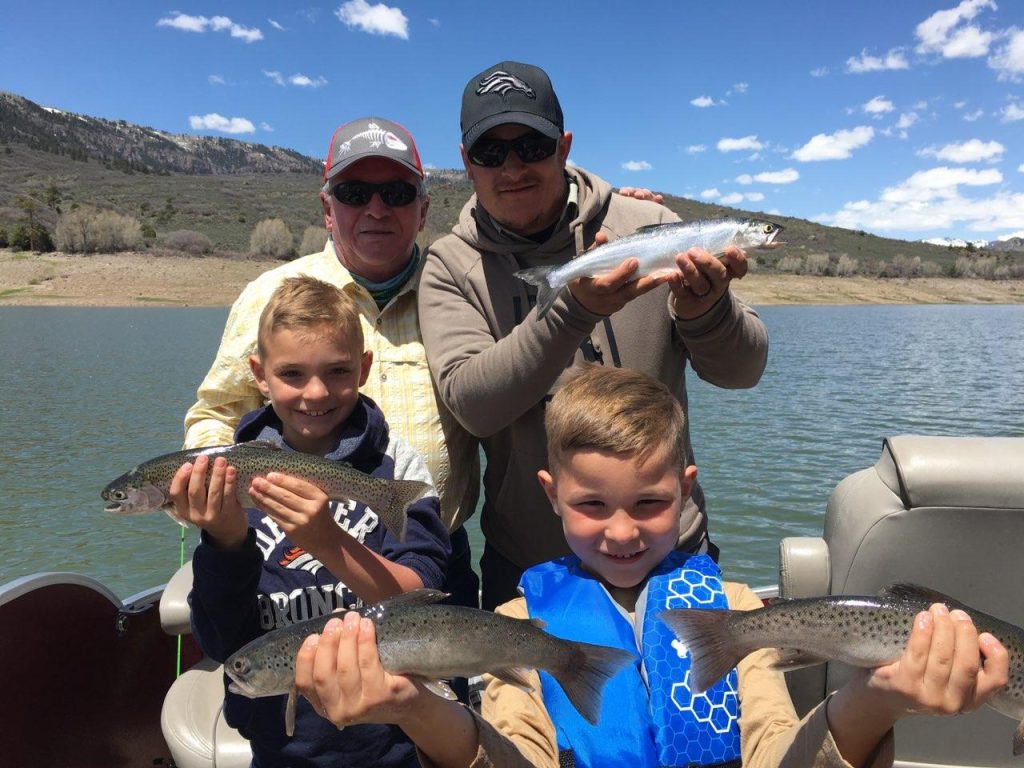 GSO Fishing Summer Vacation Fishing Trip (Family of anglers holding up their trout for the camera)